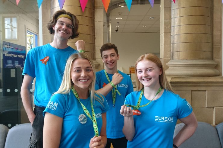 Staff showing the Sunflower lanyards and wristbands at Eureka!